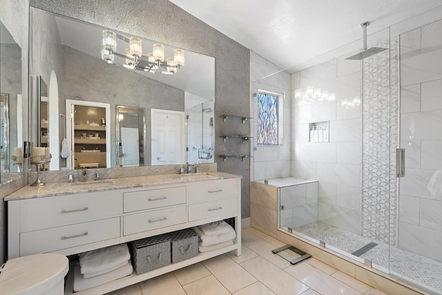 full bath with vaulted ceiling, a stall shower, a sink, and an inviting chandelier