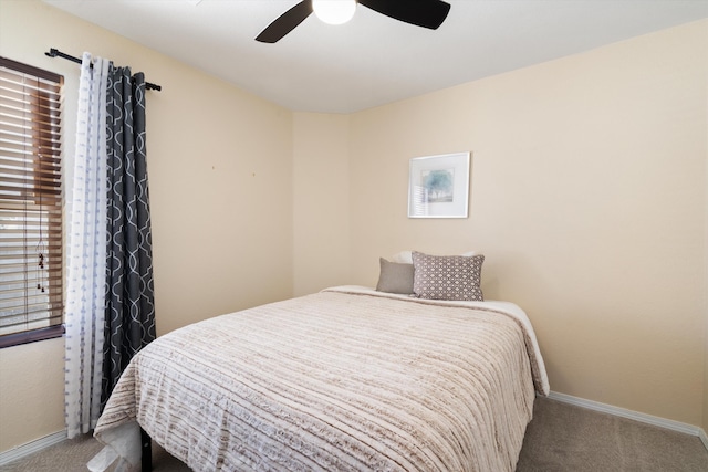 carpeted bedroom featuring ceiling fan and baseboards