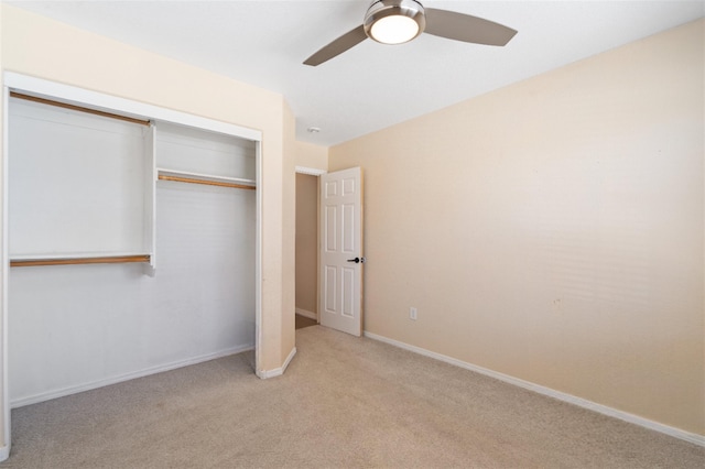 unfurnished bedroom featuring light carpet, a closet, a ceiling fan, and baseboards