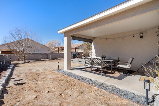 view of patio featuring outdoor dining space and a fenced backyard