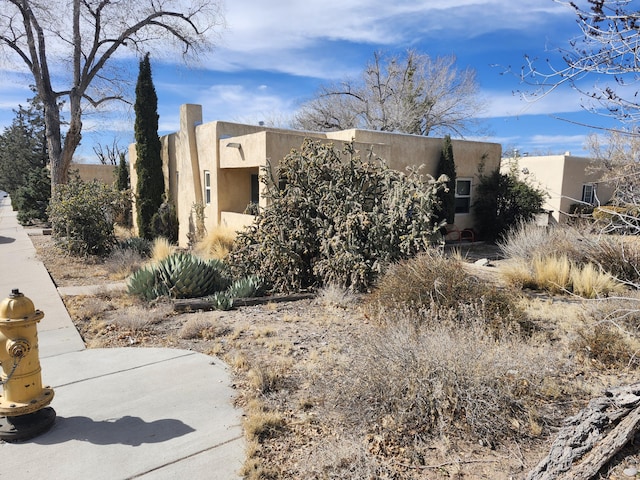 view of side of property with stucco siding