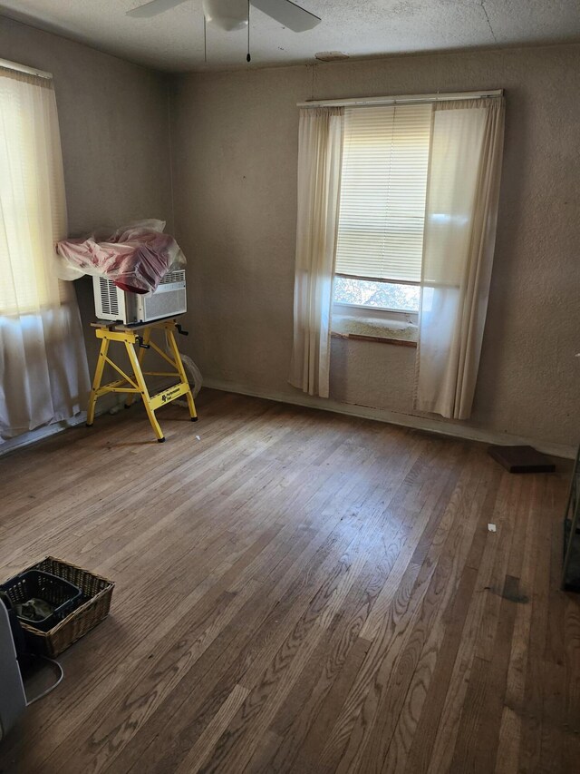 spare room featuring wood-type flooring and a ceiling fan