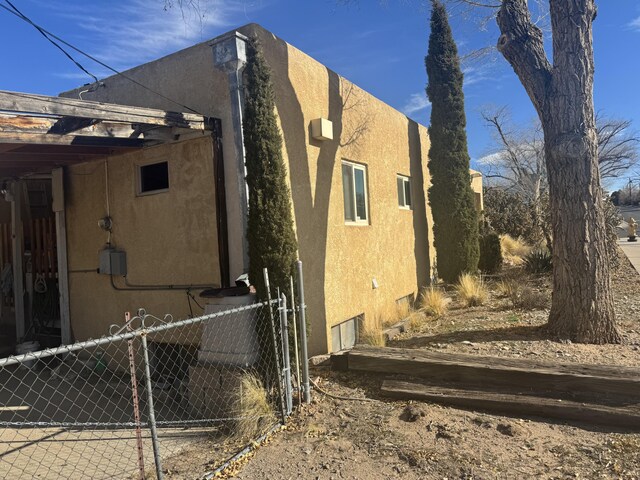 view of home's exterior featuring fence and stucco siding