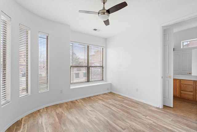 unfurnished bedroom with visible vents, light wood finished floors, and multiple windows