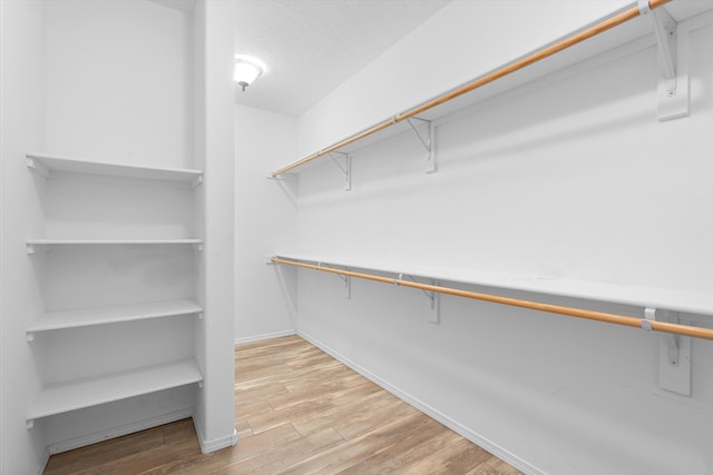 spacious closet with light wood-style floors