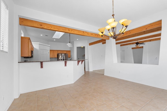 interior space with brown cabinetry, stainless steel fridge with ice dispenser, a kitchen breakfast bar, beamed ceiling, and recessed lighting