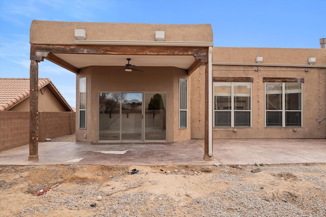 back of property featuring a patio, fence, and stucco siding