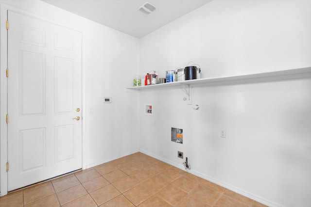 washroom with washer hookup, laundry area, gas dryer hookup, and light tile patterned floors