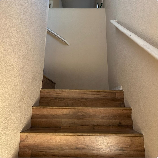 staircase with a textured wall