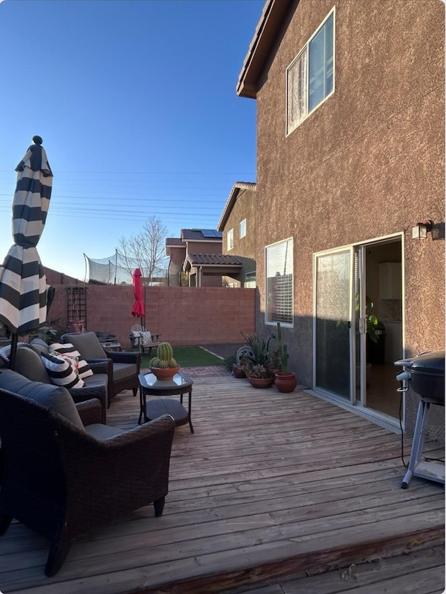 wooden terrace with fence, an outdoor living space, and area for grilling