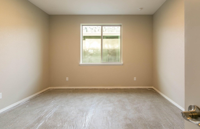 unfurnished room with baseboards