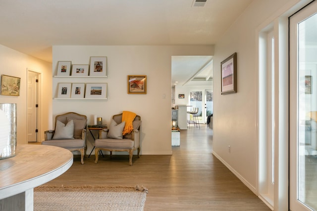 sitting room with wood finished floors and baseboards