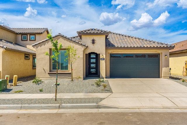 6209 Angelou Ln NW, Albuquerque, NM 87120 - mediterranean / spanish home with an attached garage, concrete driveway, a tiled roof, and stucco siding