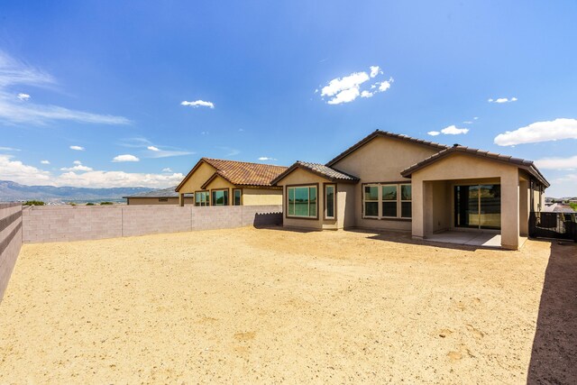 6209 Angelou Ln NW, Albuquerque, NM 87120 - rear view of property featuring stucco siding, a fenced backyard, a patio area, a tile roof, and cooling unit