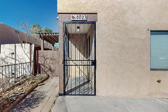 exterior space featuring fence and stucco siding