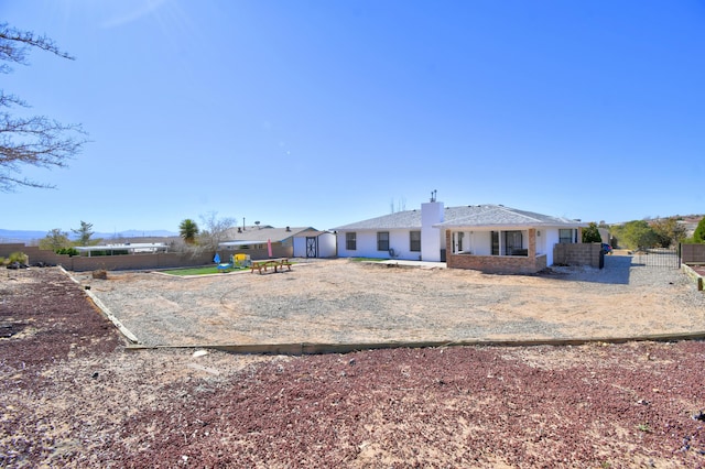 back of house featuring fence