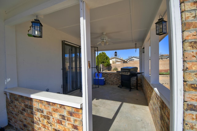 view of patio / terrace with area for grilling, ceiling fan, and fence