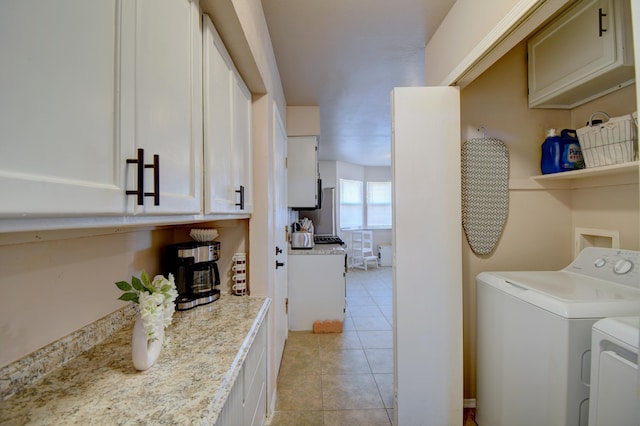 laundry area featuring light tile patterned floors, separate washer and dryer, and laundry area