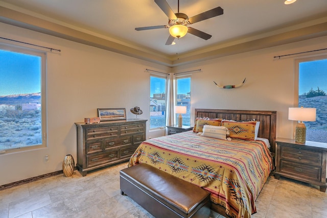 bedroom featuring ceiling fan and baseboards