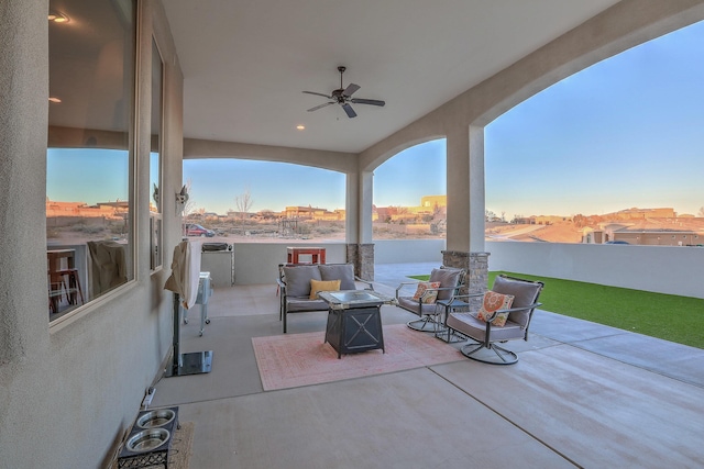 view of patio with a water view, outdoor lounge area, and a ceiling fan