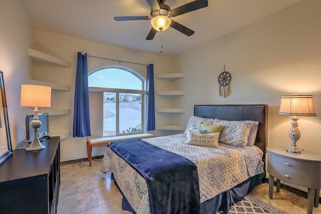 bedroom with ceiling fan, baseboards, and light tile patterned floors