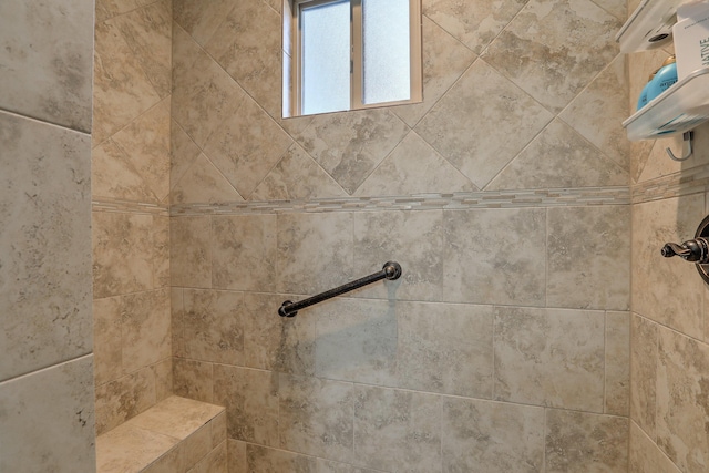 interior details featuring a tile shower