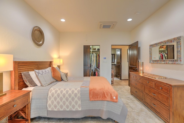 bedroom featuring visible vents, a walk in closet, a closet, and recessed lighting