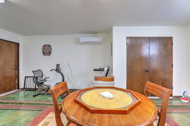 interior space featuring a textured ceiling, concrete floors, and a wall mounted AC