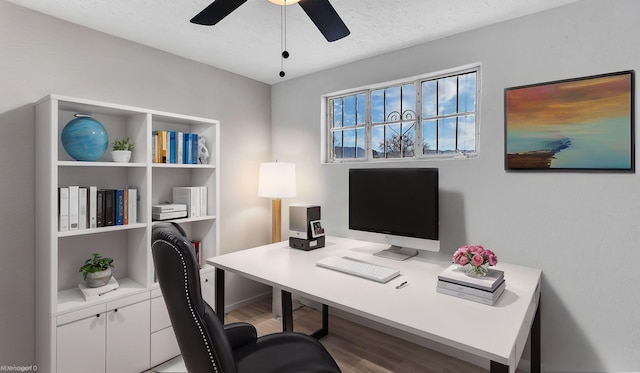 office area with a textured ceiling, a ceiling fan, and wood finished floors