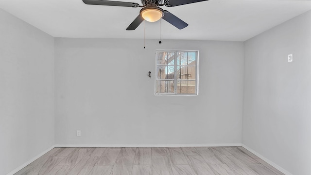 unfurnished room with baseboards and ceiling fan