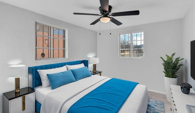 bedroom featuring baseboards and ceiling fan