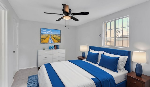 bedroom featuring baseboards and ceiling fan