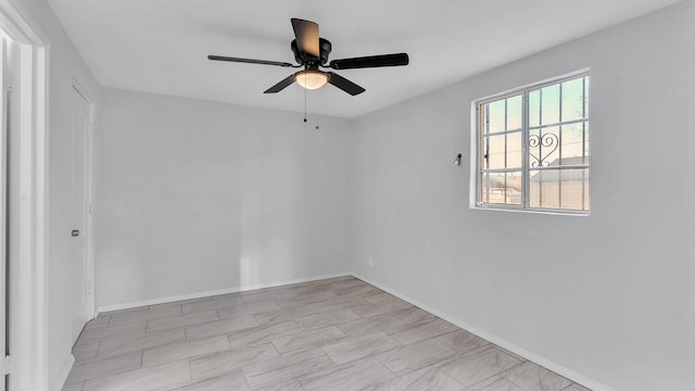 unfurnished room with baseboards and ceiling fan