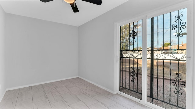 unfurnished room with baseboards and a ceiling fan