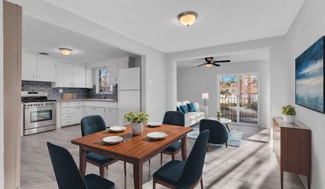 dining area with a ceiling fan and a wealth of natural light