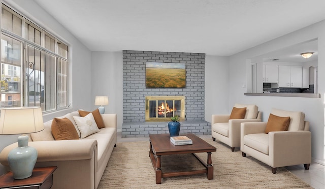 living room with light tile patterned floors and a fireplace