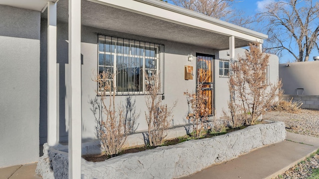 view of exterior entry with stucco siding