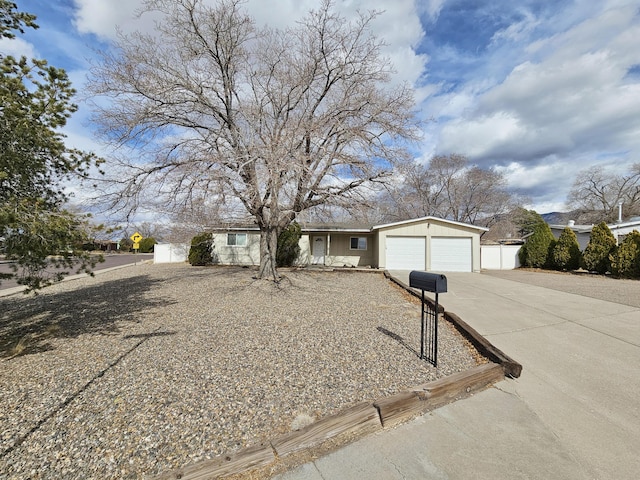 ranch-style house with driveway and an attached garage