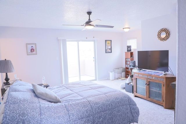 bedroom with multiple windows, carpet floors, a textured ceiling, and a ceiling fan