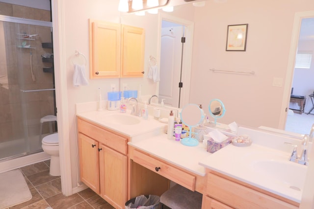 bathroom with vanity, toilet, and a shower stall