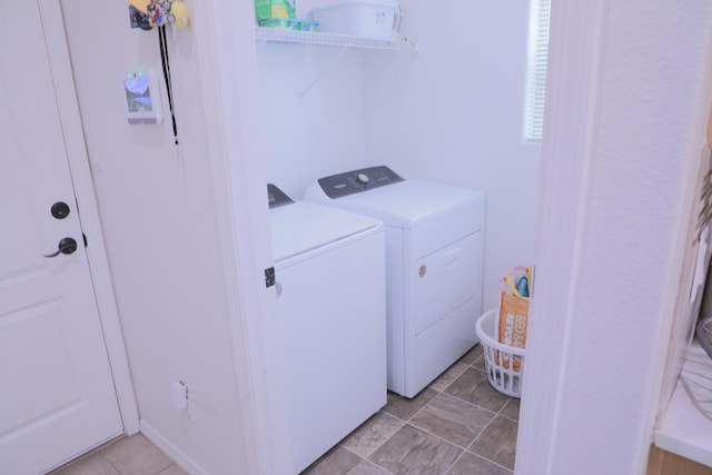 laundry room with laundry area, light tile patterned floors, and separate washer and dryer