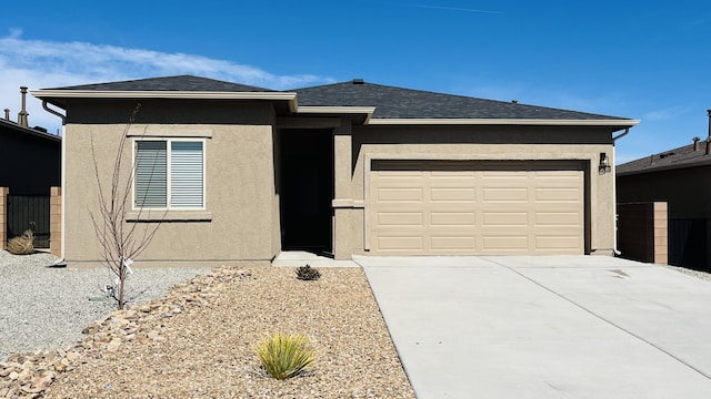 view of front facade with a garage, driveway, roof with shingles, and stucco siding