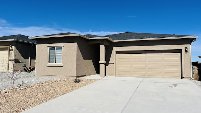 5030 Grace St, Los Lunas, NM 87031 - view of front facade featuring stucco siding, an attached garage, and concrete driveway