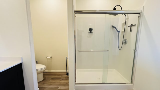 5030 Grace St, Los Lunas, NM 87031 - bathroom with a shower stall, vanity, and wood finished floors