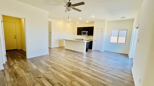 5030 Grace St, Los Lunas, NM 87031 - unfurnished living room featuring ceiling fan, light wood-type flooring, and recessed lighting