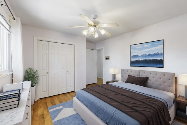 bedroom with ceiling fan, a closet, and light wood-type flooring