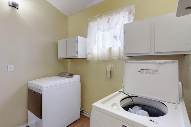 laundry room with cabinet space and washer and clothes dryer