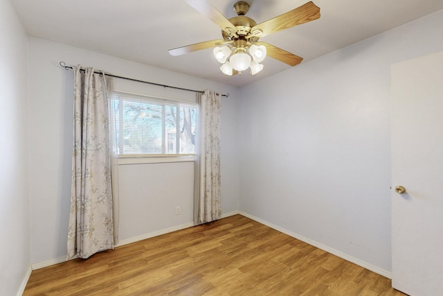 unfurnished room with a ceiling fan, light wood-type flooring, and baseboards