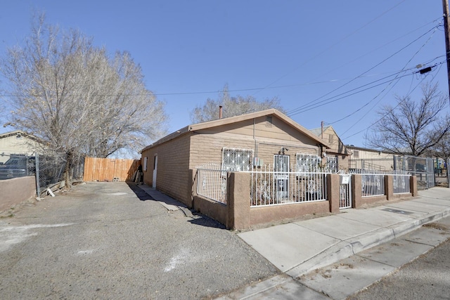 view of front of home with a fenced front yard and brick siding