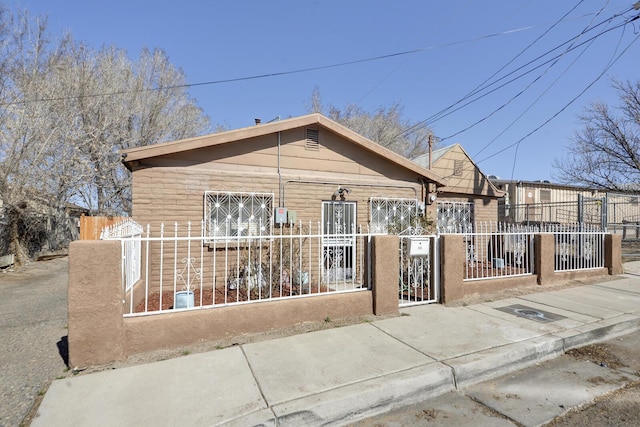 bungalow-style home featuring a fenced front yard and a gate